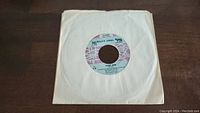 Billy Joel Piano Man 45rpm single in white paper sleeve showing label artwork