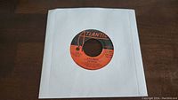 Vinyl record with orange Atlantic label showing song: "D'Yer Mak'er" by Led Zeppelin, in plain white sleeve.