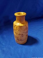 Photo of a small, light-colored birdseye wooden turned vase with smooth polished finish, showing natural wood patterns.
