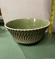 Side view of the bowl showing the textured birch bark pattern on the exterior and the tape measure indicating height close to 4 inches.