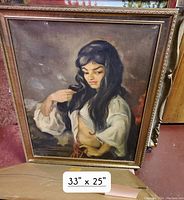 Full view of the framed oil painting showing a Romani woman in traditional attire with long hair, 33 inches x 25 inches in an ornate gold frame.