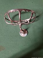 Top view of antique metal oval wall mount sponge holder showing scalloped edging and mounting post