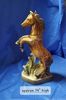 Front view of the ceramic horse decanter against blue background, approximately 14 inches tall.