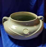 Front angled view showing shape, handles, vent hole and glaze finish