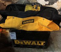 DeWalt tool bag and tool box stacked with label showing DeWalt brand and identification label.