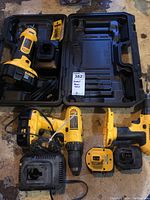 Photo of Dewalt power tools including drill, sander, reciprocating saw, two batteries, charger, and carrying case