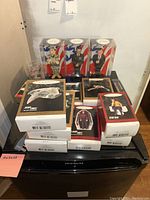 Full lot shown including several Star Trek ornaments boxed and three America's Heroes bobblehead miniatures in sealed plastic cases.