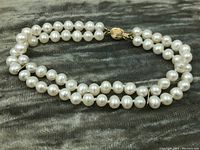 Full view of double-strand pearl bracelet laid flat