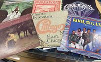 Photo showing six vinyl records from The Miracles, Climax Blues Band, Chicago, Commodores, Kool & The Gang, and Smokey Robinson.