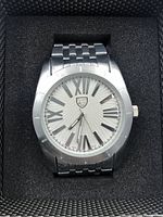 Front view of vintage Picard & Cie men's wristwatch in black foam padding inside a textured black box.