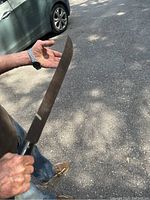 Machete held by person showing length and handle