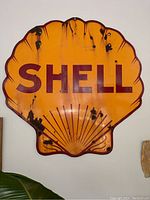 Front view of full scallop shaped sign mounted on wall