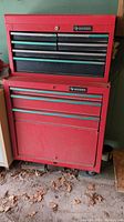 Front view of both tool cabinets stacked, showing red finish, multiple drawers, and Husky branding.