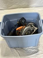 Blue plastic storage box filled with power tools