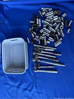 Full lot layout showing 80 pieces of sockets, ratchets, and extensions on a blue background with a white plastic basket.