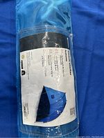 Close-up of the label on the beach shelter carrying bag showing Mountain Warehouse branding, shelter dimensions, and features.