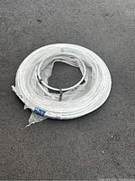 Coiled white Süperpex water pipe wrapped partially in plastic with labels visible, diameter 1/2 inch, length 100 feet.