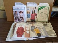 Various vintage sewing patterns showing illustrations of women in tops, jackets, and socks patterns from brands including McCall's and Green Pepper.