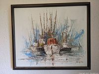 Framed painting showing group of fishing boats with tall masts in water, signed by artist, good condition with no visible damage.