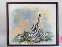 Front view of the framed painting showing the coastal scene with driftwood, grasses, and seagulls under a pastel sky.