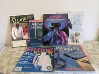 Photo of six sewing books showing covers of More Polar Fleece Adventures, Innovative Serging, Singer Sewing with the Overlock, Classic Designs for Today's Active Children, Fitting Get a Perfect Fit, and Pattern Fitting and Altering.
