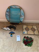 All five stained glass pieces shown together on floor including round frame, square piece, rainbow, mushroom, and birds.