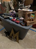 Wide view of all items atop a gray storage bin showing various trinket boxes, a wooden recipe box labeled 'RECIPES', a glass horse figurine, and decorative items.