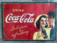 Full view of vintage Coca-Cola metal advertising sign showing artwork and text.