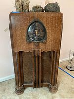 Front view of the vintage wooden Zenith radio cabinet showing overall wear and tear.