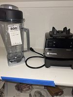 Base and blending container with lid