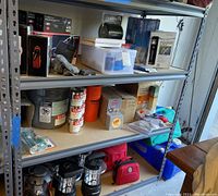 Wide shot of metal shelving units with assorted emergency items across three shelves