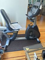 Side view of recumbent bike showing seat, backrest, frame and console