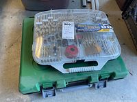 Clear plastic case of 88-piece XTRADE drill bit set on top of green Hitachi case