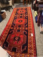 Full length view of Persian Heriz style rug laid on floor with geometric design