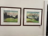 Two framed prints side by side on wall