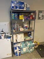 Full shelving unit showing all paper and plastic goods