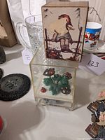 Hummel themed box with applied label showing damage, wooden, rectangular.