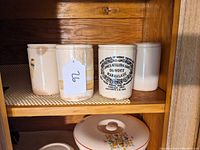 Four stoneware pots together on wooden shelf, one marked Dundee Marmalade