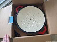 Inside of the lid showing moisture retention dimples and red exterior edges.