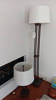 Floor lamp and table lamp positioned near wall, showing full height and bases.