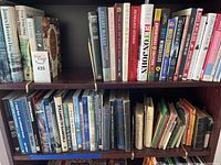 Shelves filled with various books on history, music, war, and adventure.