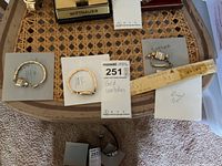 Three watches arranged on boards labelled '14K', '10K', and with loose band links marked GF