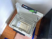 Open Sentry safe showing interior and certificate inside.