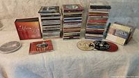 Full view of all music CDs laid out and stacked including some compilation albums and single releases.