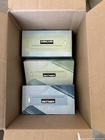 Top-down view of opened carton containing individual boxes of Kirkland facial tissues in original packaging.