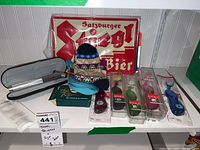 Top view showing multiple Radius toothbrushes in packaging, a metal beer sign, and other small items on a white surface.