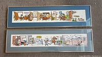 Two framed horizontally oriented offset lithographs, colorful cartoon-style, with office scenes involving animals, matted in blue.