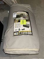 Guest bed rolled up in beige carrying case with label showing 'Guest Bed' and product details.