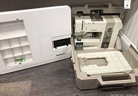 Overall view of sewing machine in case with detached Alphasew table extender alongside