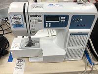 Full side view showing LCD screen, stitch patterns panel on front, and Brother branding.